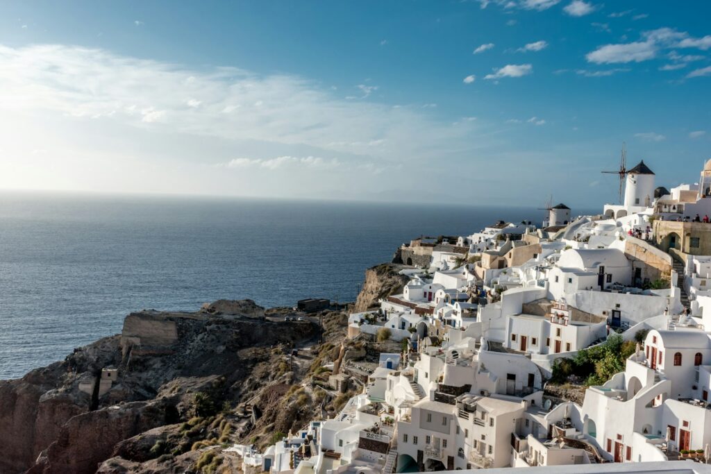white concrete houses near sea under blue sky during daytime